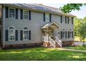 Charming two-story home with gray siding, black shutters, and a welcoming front porch at 1575 Lewis Farm Rd, Kings Mountain, NC 28086