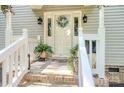 Inviting front porch with plants and a decorative wreath on the front door at 1575 Lewis Farm Rd, Kings Mountain, NC 28086