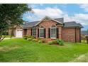 Charming brick home featuring a landscaped yard and classic black shutters at 1909 Wexford Ct, Gastonia, NC 28054