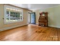 Inviting living room with hardwood floors, and a vintage organ near a bright window at 204 Blanche Ave, Belmont, NC 28012