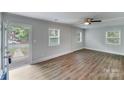Bright living room featuring hardwood floors, three windows with natural light, and an open entry at 2214 Grimes St, Charlotte, NC 28206