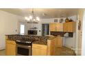 Bright kitchen featuring light wood cabinets, granite countertops, and stainless steel appliances at 229 W Park Ave, Mooresville, NC 28115