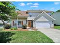 Charming home with an orange front door, a white garage door, and a cozy front porch at 2706 Stagbuck Dr, Gastonia, NC 28052