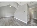 An open living space features a high vaulted ceiling, a ceiling fan, gray flooring, and a staircase at 2706 Stagbuck Dr, Gastonia, NC 28052