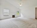 Bright living room with vaulted ceilings, plush carpeting, and a cozy fireplace at 2927 Dubberly Ct, Matthews, NC 28105