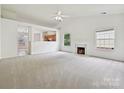 Spacious living area featuring vaulted ceilings, neutral carpeting, and a marble fireplace at 2927 Dubberly Ct, Matthews, NC 28105
