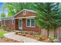 Attractive brick home with manicured flower beds and walkway leading to the front door at 2953 Enfield Rd, Charlotte, NC 28205