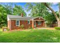 Lovely brick home with green lawn and well-placed landscaping elements adding curb appeal at 2953 Enfield Rd, Charlotte, NC 28205