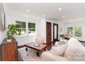 Bright living room with hardwood floors, a patterned rug, and comfortable seating near large windows at 3331 Eastwood Dr, Charlotte, NC 28205