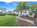 Charming white one-story home with a well-maintained lawn and lush landscaping at 3809 Topsfield Rd, Charlotte, NC 28211