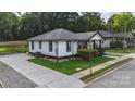 Charming bungalow with black and white trim, inviting porch, and manicured landscaping at 418 Link St, Fort Mill, SC 29715