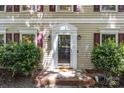 Close-up of the home's entrance, featuring a classic front door and well-maintained landscaping at 4232 Saint Audrey Pl, Charlotte, NC 28269