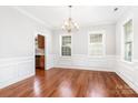 Formal dining room featuring hardwood floors, decorative molding, and elegant chandelier lighting at 4504 Sages Ave, Indian Trail, NC 28079