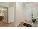 Bright foyer features hardwood flooring, neutral walls, and access to other rooms in the home at 608 Camrose Ne Cir, Concord, NC 28025