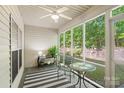 Inviting screened porch with comfortable seating, ceiling fan, and views of the backyard at 608 Camrose Ne Cir, Concord, NC 28025