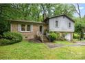Split level home with a brick and gray wood facade and attached one car garage at 610 N Shaver St # 14, Salisbury, NC 28144