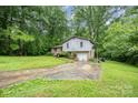 Split level home surrounded by lush greenery and mature trees, offering privacy and shade at 610 N Shaver St # 14, Salisbury, NC 28144