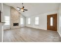 Spacious living room with a stone fireplace, vaulted ceiling, and modern flooring at 752 Chipmeadow Ln, York, SC 29745