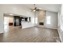 Open-concept living room with stone fireplace, modern floors, and a view into the kitchen at 752 Chipmeadow Ln, York, SC 29745