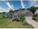 Well-manicured lawn leading up to the charming single Gathering home with stone accents at 120 Autumn Mist Rd, Statesville, NC 28677