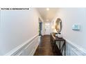 Well-lit foyer features hardwood flooring, decorative molding, and console table at 125 Asmodean Ln, Troutman, NC 28166