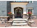 Inviting front entrance with double doors, stone steps, and decorative planters at 13837 Grand Palisades Pkwy, Charlotte, NC 28278