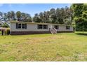 Single-story home featuring vinyl siding, a brick foundation, and well-kept lawn at 151 Lillyfield Dr, Rockwell, NC 28138