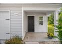 Charming front porch with an inviting entrance featuring a black front door and decorative flower basket at 155 Trail Wood Ct, Salisbury, NC 28146