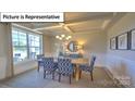 Bright dining room with large windows and coffered ceilings at 160 Asmodean Ln, Troutman, NC 28166