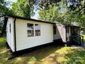 Well-maintained single-story home showcasing a screened-in porch, neutral paint, and lush landscaping for serene outdoor living at 20016 Walter Henderson Rd, Cornelius, NC 28031