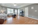 Inviting living room with hardwood floors, neutral paint, and tray ceiling at 2023 E Park Dr, Lancaster, SC 29720