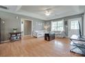 Comfortable living room featuring wood floors, floral sofas and lots of natural light at 2023 E Park Dr, Lancaster, SC 29720