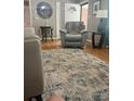Comfortable living room with a leather recliner and hardwood floors at 202 Kenwood Ave, Cherryville, NC 28021