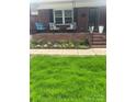 Cozy front porch featuring a swing and flower bed, perfect for relaxing outdoors at 202 Kenwood Ave, Cherryville, NC 28021