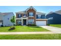 Charming two-story brick home with well-maintained landscaping and a two-car garage at 256 W Waterlynn Rd, Mooresville, NC 28117