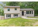 Charming home with a freshly painted brick and siding exterior, complemented by black shutters and well-maintained landscaping at 3121 Revolution Park Dr, Charlotte, NC 28217
