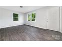 Bright living room with natural light, featuring modern gray flooring and freshly painted neutral walls at 3121 Revolution Park Dr, Charlotte, NC 28217