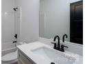 Modern bathroom features white vanity with black hardware, toilet, and tiled shower at 315 W Hoke W St, Landis, NC 28088
