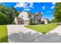 Beautiful home featuring a spacious driveway, well-maintained lawn, and a convenient three-car garage at 3918 Halcyon Dr, Huntersville, NC 28078