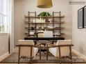 Stylized office featuring a dark desk, cozy chairs, and shelving filled with books and decor at 4179 Skyboat Cir, Fort Mill, SC 29715
