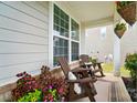 Inviting front porch with cozy seating, plants and view of the yard at 4527 Waylon Ave, Fort Mill, SC 29715