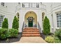Inviting front entrance with brick steps, a decorative wreath, and professionally landscaped surroundings at 469 Valley Run Dr, Waxhaw, NC 28173