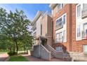 Beautiful townhome exterior with a well-maintained brick walkway and lush green trees at 511 Donatello Ave, Charlotte, NC 28205