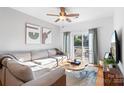 Bright living room featuring a large sectional couch and balcony access at 511 Donatello Ave, Charlotte, NC 28205