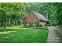 Well-maintained brick home with lush greenery, a neatly manicured lawn, and a paved driveway at 5208 Black Oak Ln, Waxhaw, NC 28173