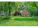 Beautiful brick home with well-manicured lawn and lush landscaping, showcasing curb appeal at 5208 Black Oak Ln, Waxhaw, NC 28173