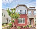 Charming townhome showcasing brick accents, complemented by a well-manicured lawn and lush landscaping at 5391 Orchid Bloom Dr, Fort Mill, SC 29707