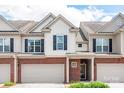Attractive townhome featuring a brick facade and covered entryway at 5951 Carrollton Ln, Charlotte, NC 28210