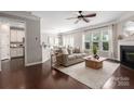 Bright living room with dark wood floors, a fireplace, and an open concept design at 5951 Carrollton Ln, Charlotte, NC 28210