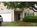 Inviting front entrance with a covered porch, complemented by manicured shrubs at 6105 Follow The Trl, Indian Trail, NC 28079